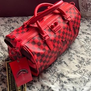 A brand new red bape travel bag